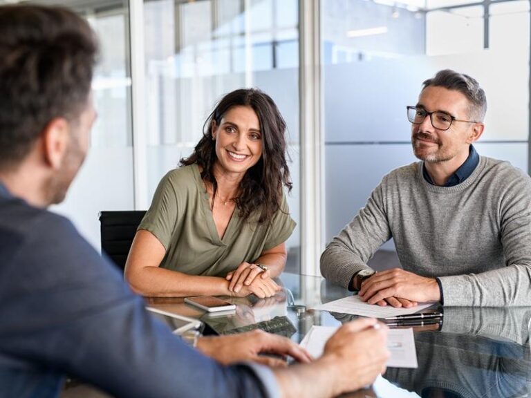 People discussing financial advice in office.